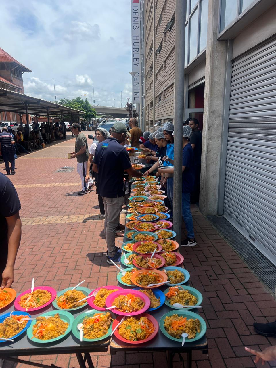 TME Logistics team serving food at community outreach